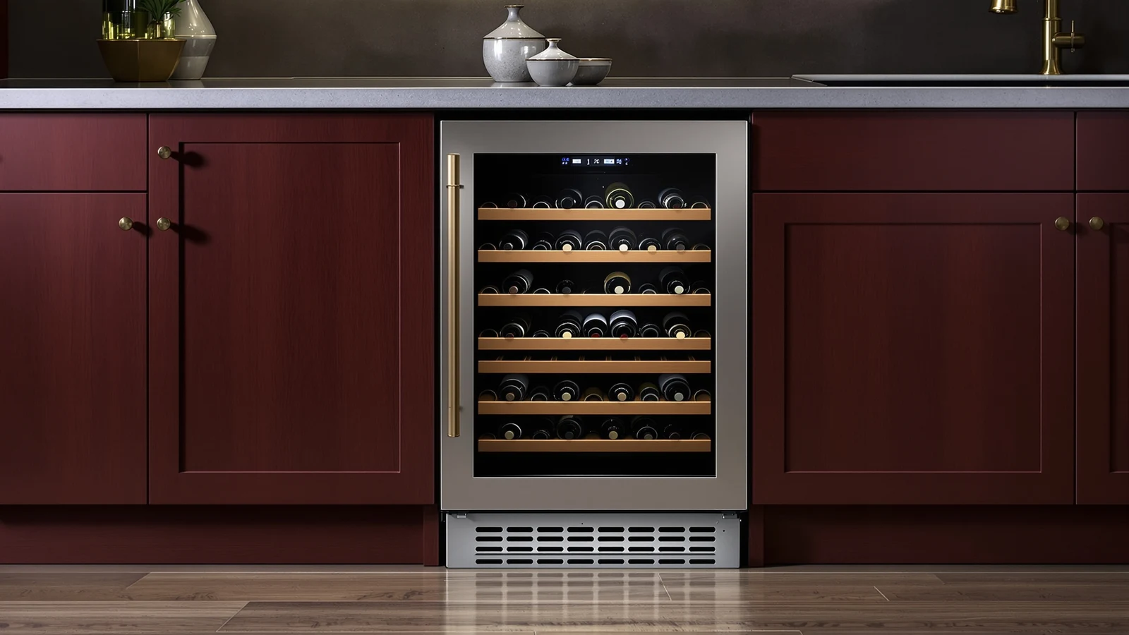 A built-in wine refrigerator installed under a kitchen counter beside a freestanding wine cooler standing in open floor space